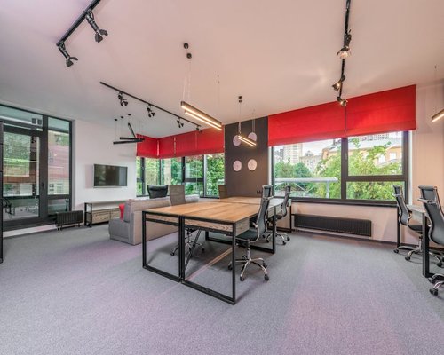 A wide view of an organized clean workspace that supports good ergonomics and comfortable daylight placement